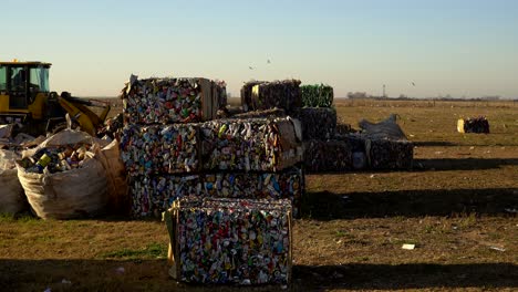 A-bulldozer-passes-by-compacted-waste-towards-a-dumping-ground-in-a-waste-processing-facility