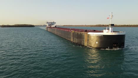 Aerial-backwards-following-shot-of-a-Freighter-on-Detroit-River-near-Wyandotte-Michigan,-USA