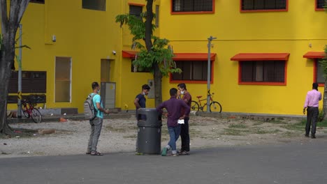 People-smoking-at-public-square-in-Little-India,-Singapore