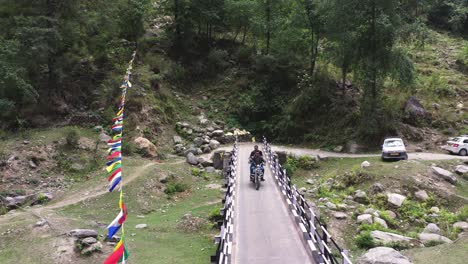 Aerial-shot-of-water-stream-flowing-near-the-rocks-with-a-mountain-in-the-background