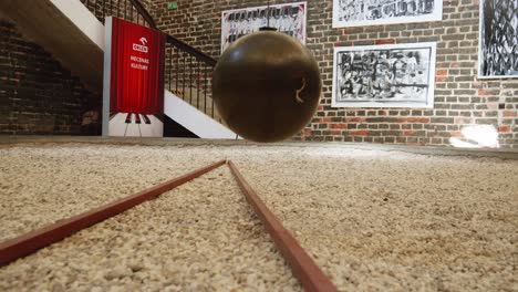 Slow-Motion-Of-Huge-Foucault's-Pendulum-In-The-Premises-Of-The-Ancient-Planetarium-Bell-Tower,-Frombork,-Poland