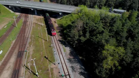 Aerail-view,-train-with-attached-wagons-passes-under-the-bridge