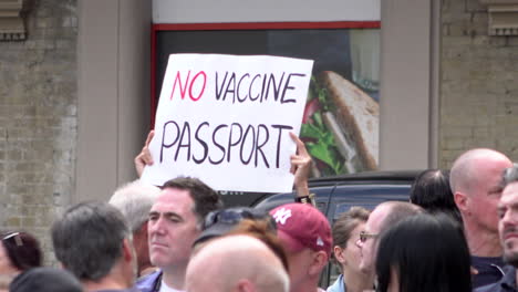 Ein-Demonstrant-Hält-Bei-Einem-Protest-Gegen-Eine-Coronavirus-Verschwörung-Ein-Plakat-Mit-Der-Aufschrift-„Kein-Impfpass“-Hoch