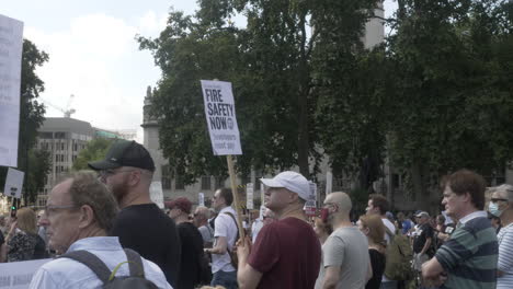 Men-and-women-stand-together-with-placards-in-their-hands-to-show-solidarity-for-Leaseholders-Together-Rally-in-Parliament-Square