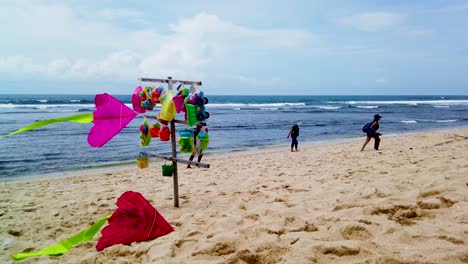 Vendors-selling-toys-on-Indrayanti-beach,-Yogyakarta,-Indonesia,-stand-close-up