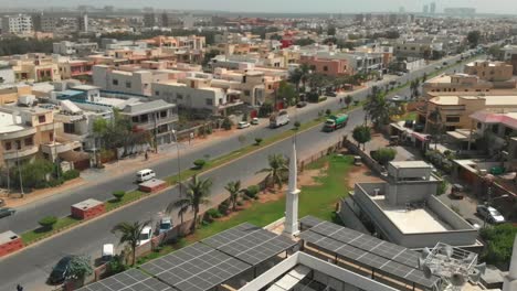 Aerial-View-Over-Solar-Panels-On-Jamia-Masjid-Bilal-In-Karachi-Next-To-Khayaban-Ittehad-Road