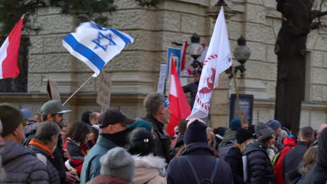 Fast,-close-up-pan-across-many-protestors-marching-against-corona-measures-in-Vienna,-Austria