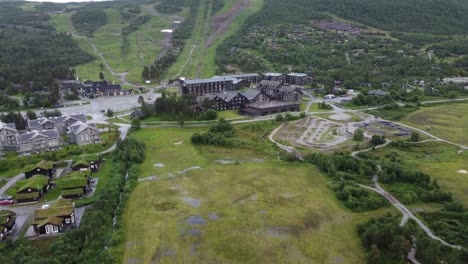 Approaching-Vestlia-Hotel-and-Lodge-with-bicycle-pumptrack-and-happy-kids-on-right-side---Approaching-aerial-during-summer-vacation---Norway