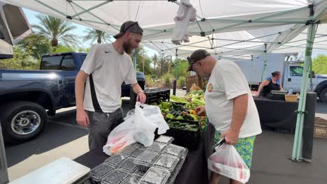 Man-shopping-at-outdoor-farmers-market