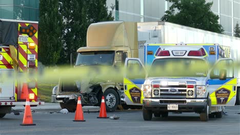 Crashed-lorry-in-street-with-emergency-vehicles-and-yellow-tape,-static-view