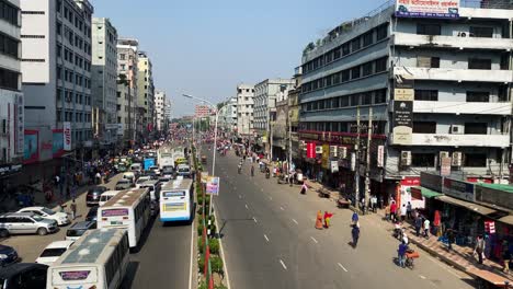 Toma-Panorámica-De-La-Calle-Del-Distrito-De-Mirpur,-Antigua-Dhaka-Con-Vista-De-Autobuses-Y-Gente-En-La-Calle