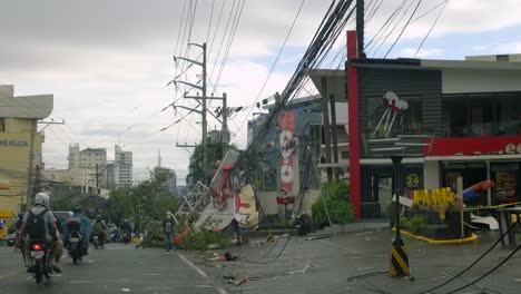 Motorcycle-traffic-on-road-in-aftermath-of-Typhoon-Rai,-Philippines