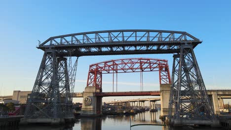 Low-push-out-of-famous-steel-bridges-over-still-river-in-Buenos-Aires