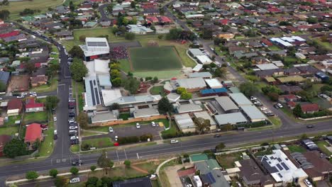 AERIAL-Over-Primary-Elementary-School,-Group-Of-Students-Near-Gymnasium