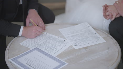 Signing-of-marriage-papers-with-bride-and-groom