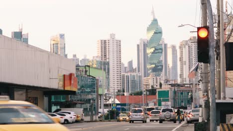 wide-shot-of-the-Fernandez-de-Cordoba-metro-station,-in-the-distance-a-scenic-backdrop-of-the-El-Tornillo-F-and-F-Tower-as-the-suns-golden-rays-shine-through-the-beautiful-cityscape,-Panama-City