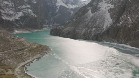 Aerial-View-Of-Attabad-Lake-Next-To-Karakoram-Highway,-Hunza-Valley-In-Gilgit−Baltistan,-Pakistan---drone-shot