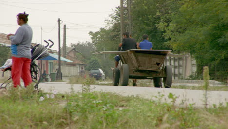 A-traditional-horse-drawn-cart-carrying-plaster-board-trundles-down-a-road