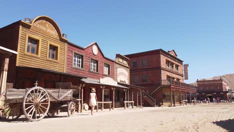 Girl-walking-at-Oasis-Mini-Hollywood-in-the-Tabernas-Desert-in-Almeria,-Andalucia,-Spain