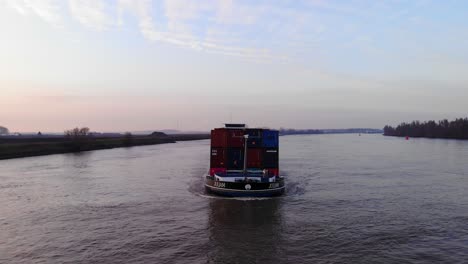 Aerial-Parallax-Around-Forward-Bow-Of-Juliam-Cargo-Ship-Along-Oude-Maas-During-Golden-Hour