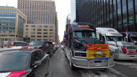 Freedom-Convoy-Truckers-Vigorously-Protest-Against-COVID-Vaccine-Mandates-blocking-streets-in-Ottawa,-Ontario,-Canada-Using-Their-Forces-and-Encouragement-Against-the-Sanitary-Dictatorship