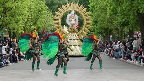 People-Watching-Dancers-In-Costume-Dancing-In-Front-Of-Float-With-Bear-Mascot-At-Carnival-Square-In-Everland