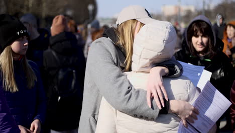 Two-Ukrainian-girls-meet-at-the-registration-center-at-the-National-Stadium-in-Warsaw-to-receive-the-Polish-social-security-number