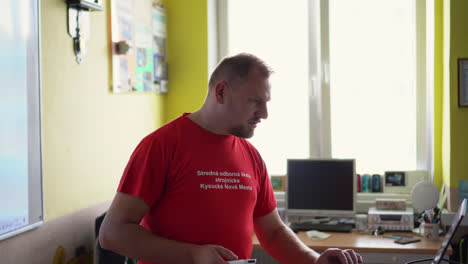 Adult-male-teacher-presenting-a-lesson-to-a-classroom-of-young-students-at-vocational-high-school-in-Slovakia