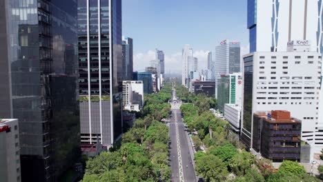 Aerial-Flying-In-Between-Buildings-Along-Reforma-Avenue-Towards-The-Angel-Of-Independence-In-Mexico-City