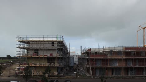 Timelapse-at-construction-site-with-dramatic-clouds-passing-by-and-rainbow-appearing-above