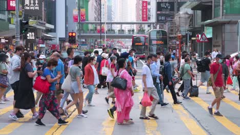 Pedestrians-rushing-and-walking-at-a-hectic-and-busy-zebra-crossing-junction-in-one-of-the-most-heavily-frequented-areas-in-the-city