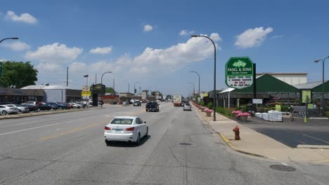 Traveling-in-the-Illinois-Chicago-land-area,-suburbs,-streets,-and-highways-in-POV-mode-black-truck-left-side