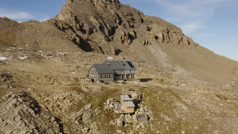 Aerial-orbit-around-mountain-hut-"Cabane-des-Becs-de-Bosson",-Valais---Switzerland