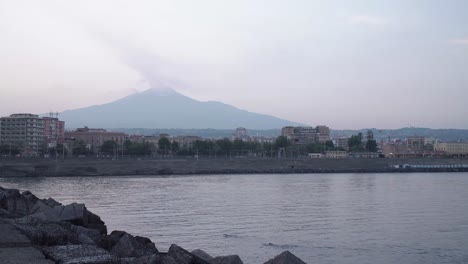 Zwei-Freiwasserschwimmer-In-Der-Bucht-Von-Catania,-Italien,-Mit-Dem-Rauchenden-Ätna-Im-Hintergrund