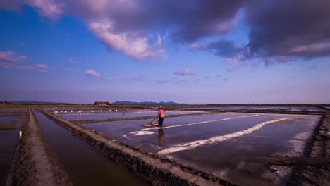 Traditional-salt-making,-forming-salt-mounds-under-the-mid-day-heat