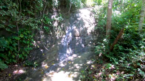 Una-Toma-Panorámica-Lenta-De-Una-Pequeña-Cascada-En-La-Exuberante-Selva-Tropical-De-Filipinas