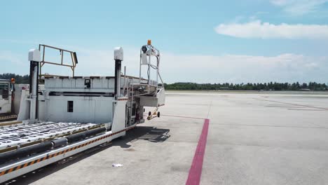 Landscape-view-of-the-Phuket-Airport-plane-parking-area-with-some-airplane-in-apron-and-airport-equipment-in-summer-daytime--4k-UHD-video