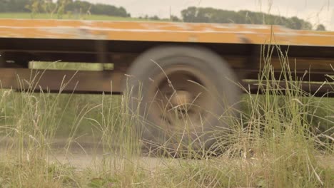 Tractor-and-trailer-passes-by-on-country-road