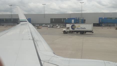 Overlooking-the-wing-in-an-airplane-while-it-taxi's-at-Dtroit-Metro-DTW