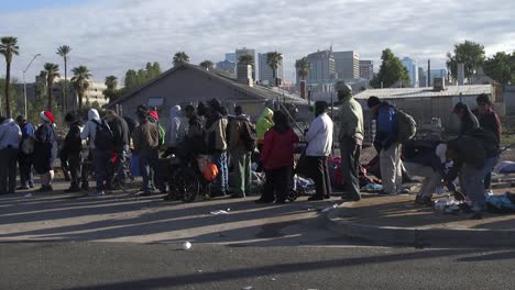 Eine-Lange-Schlange-Obdachloser-Männer-Und-Frauen-Wartet-Auf-Der-Straße-Darauf,-Das-Nötigste-Zum-Überleben-Zu-Bekommen,-Phoenix,-Arizona