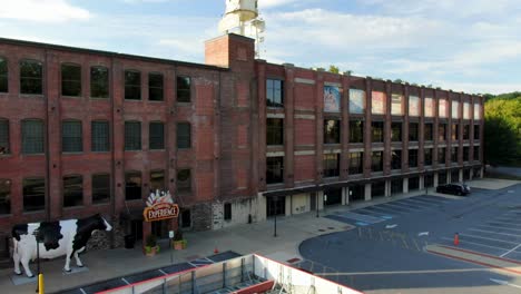 Aerial-panning-shot-of-Turkey-Hill-Experience-tourist-attraction-and-old-brick-restored-building