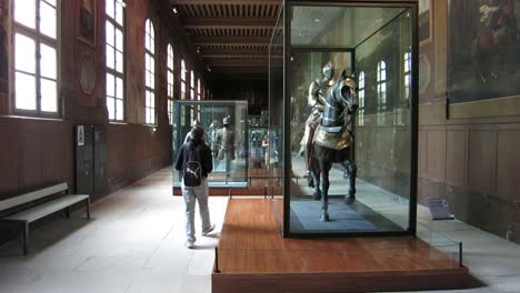 Tourist-visiting-and-taking-photos-in-the-Army-Museum,-in-Paris,-France