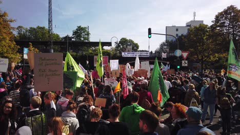 Large-group-of-protesters-on-a-climate-strike-demonstration-in-Köln---Cologne-Germany,-wielding-posters,-placards,-banners-and-flags