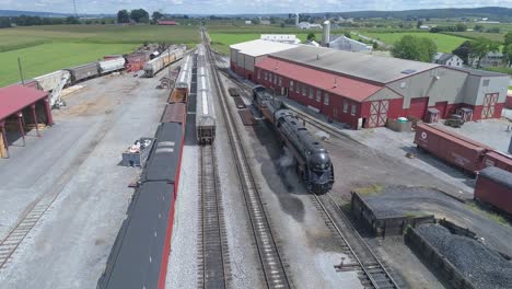 Aerial-View-of-a-Train-Yard-with-a-Steam-Engine-N-W-611-Warming-Up-on-a-Sunny-Summer-Day