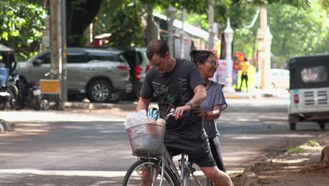 Wide-Shot-of-Tourists-on-a-Bike-in-the-Street