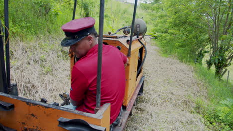 Swiss-captain-driving-old-fashioned-train-in-La-fortuna---Costa-Rica