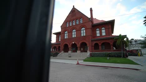 Wide-View-of-Key-West-Art-and-History-Museum-Tracking-Right-With-Street-Post-in-Foreground