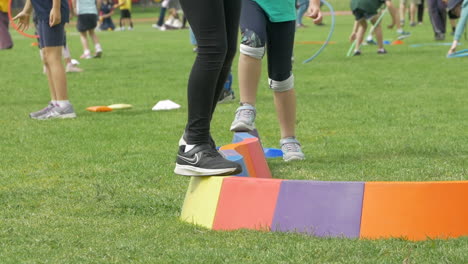 Kids-Balancing-On-Colorful-Beam-During-School-Activities,-SLOW-MOTION