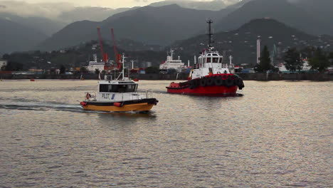 Pilot-ship-navigating-in-the-harbour,-arriving-in-the-dock,-as-seaman-stepping-out-to-the-deck