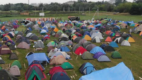 Aerial-View-of-Multi-Colored-Tents-Pitched-in-a-Field-at-a-Music-Festival